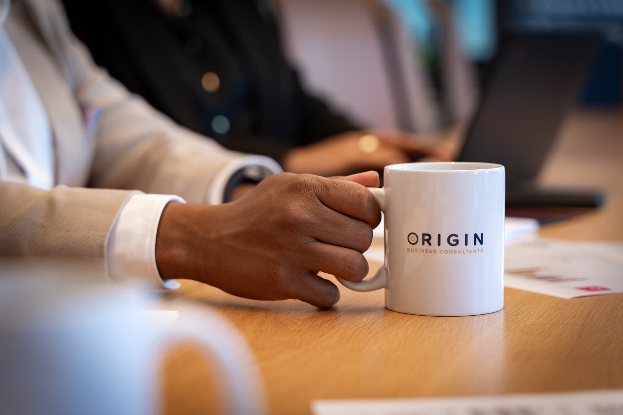 Mug being held by hand while conducting business advisory in perth